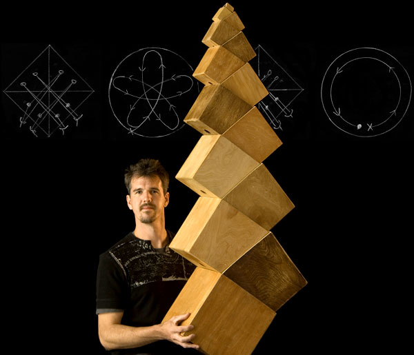Boxes: Greg Kennedy supporting a structure of stacked boxes