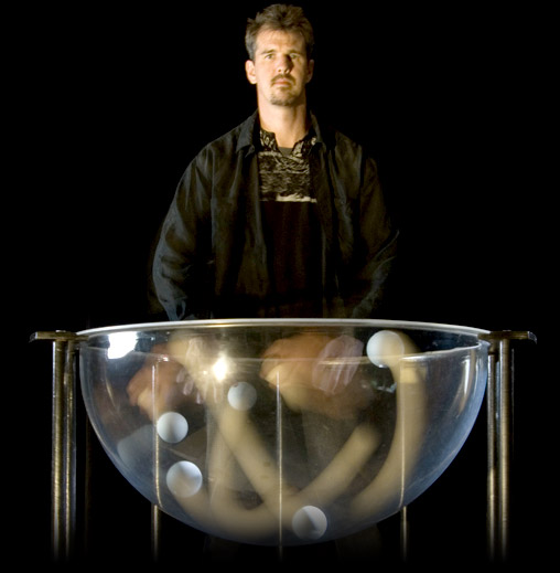 Hemisphere: Greg Kennedy juggling multiple balls in a clear half-circle container