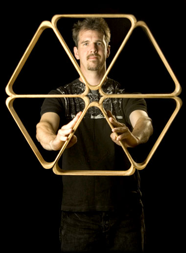 Rhombi: Greg Kennedy holding custom-built apparatus used in his performance